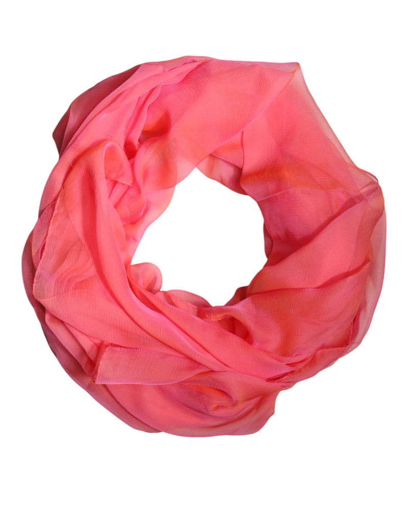 Bright pink silk wrap scarf coiled in a circular shape