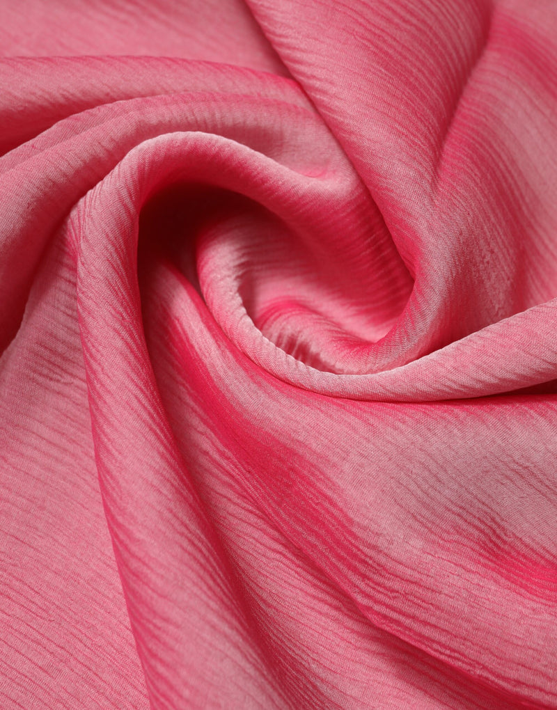 Pink silk wrap scarf with a soft, crinkled texture draped in folds