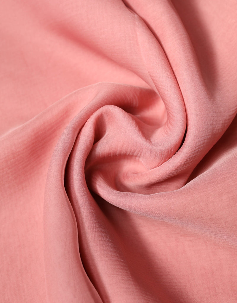 Pink silk wrap scarf draped in soft folds