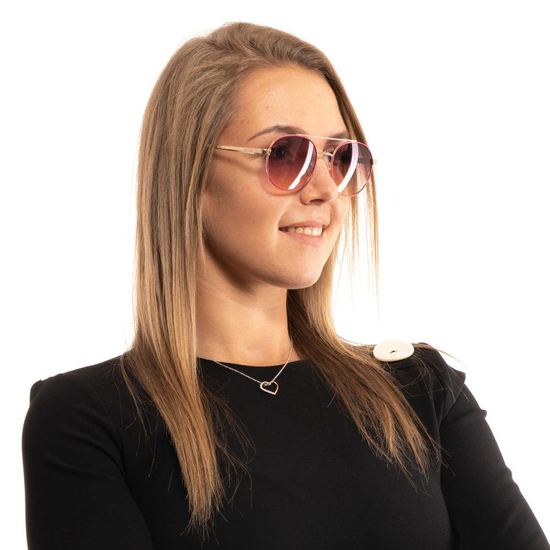 Guess rose gold metal aviator sunglasses with pink gradient lenses worn by a model