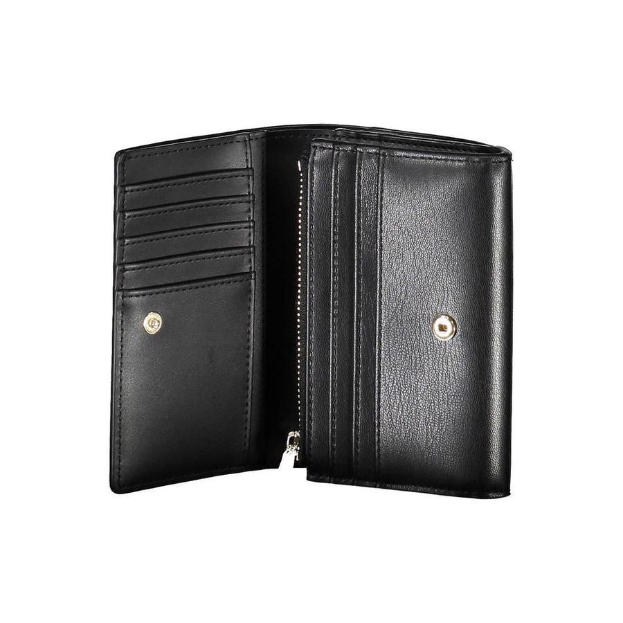 Black polyurethane trifold women's wallet with a gold metal Tommy Hilfiger logo on the front