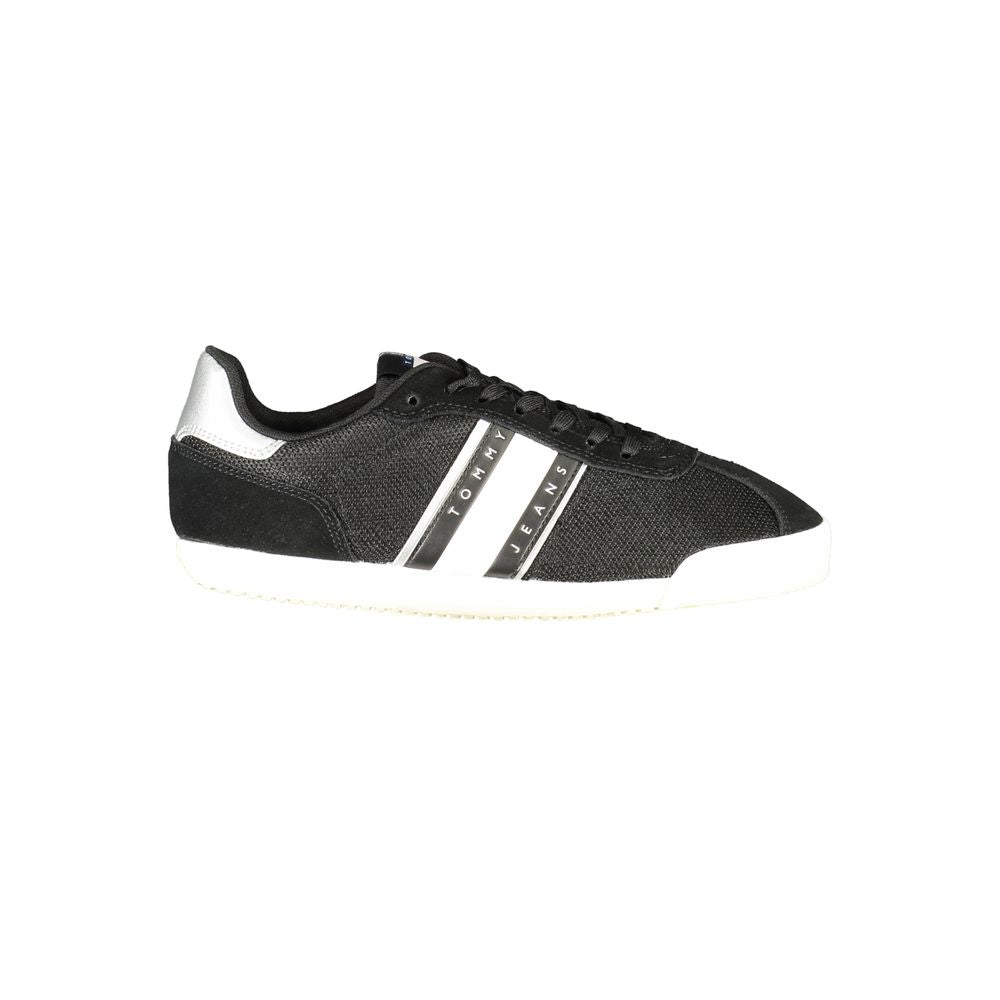 Black polyester Tommy Hilfiger sneaker with white side stripes, "TOMMY JEANS" branding, and a white rubber sole.