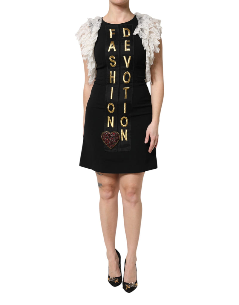 Dolce and Gabbana black mini dress with gold lettering and crystal heart embellishment and white lace sleeves