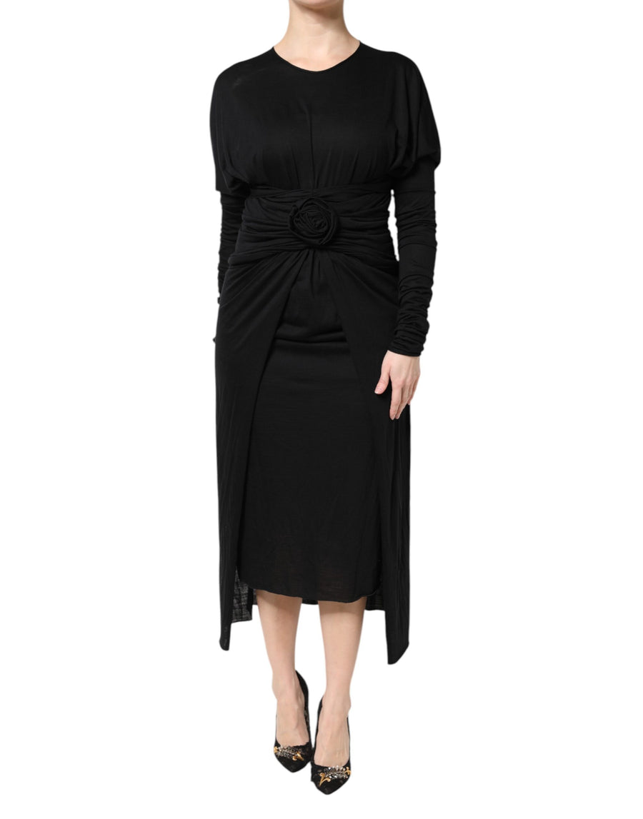 Black long-sleeve wool midi sheath dress with draped fabric and floral waist detail