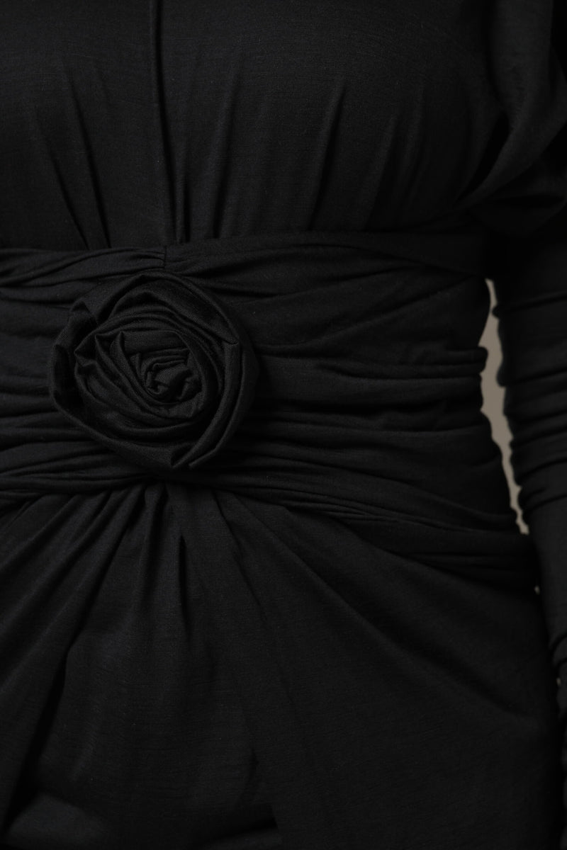 Black wool long-sleeve midi dress featuring a ruched waist and large fabric rose detail