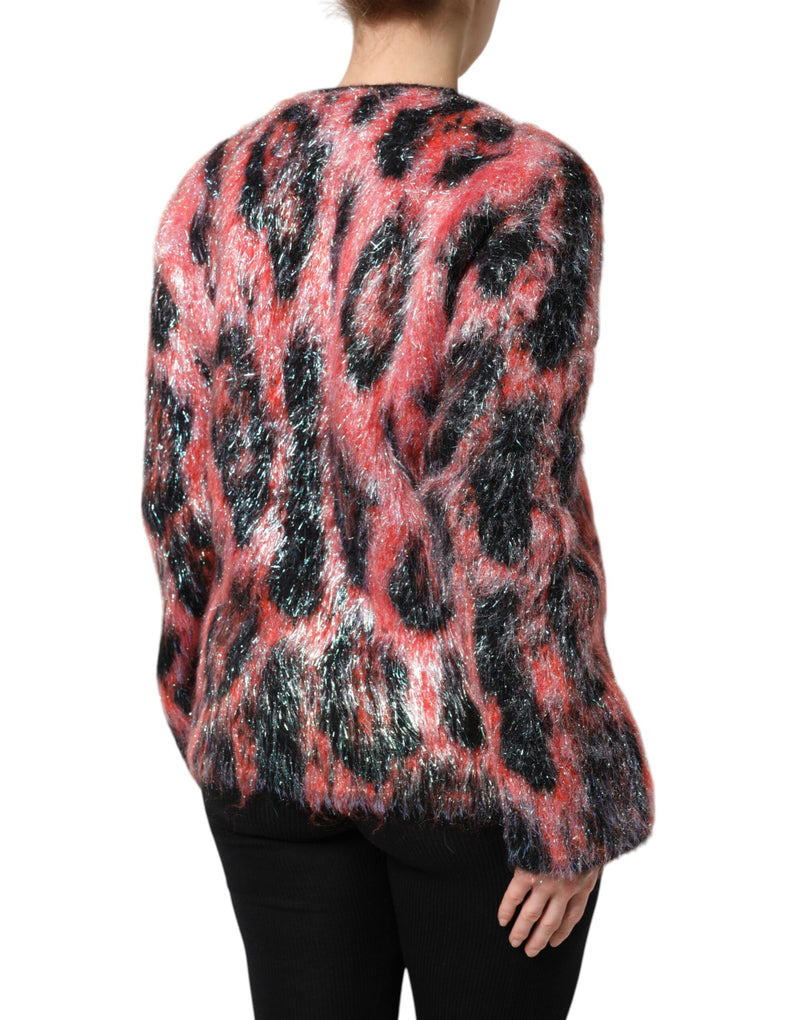 Back view of a red and black mohair wool leopard print long-sleeve cardigan sweater worn with black pants