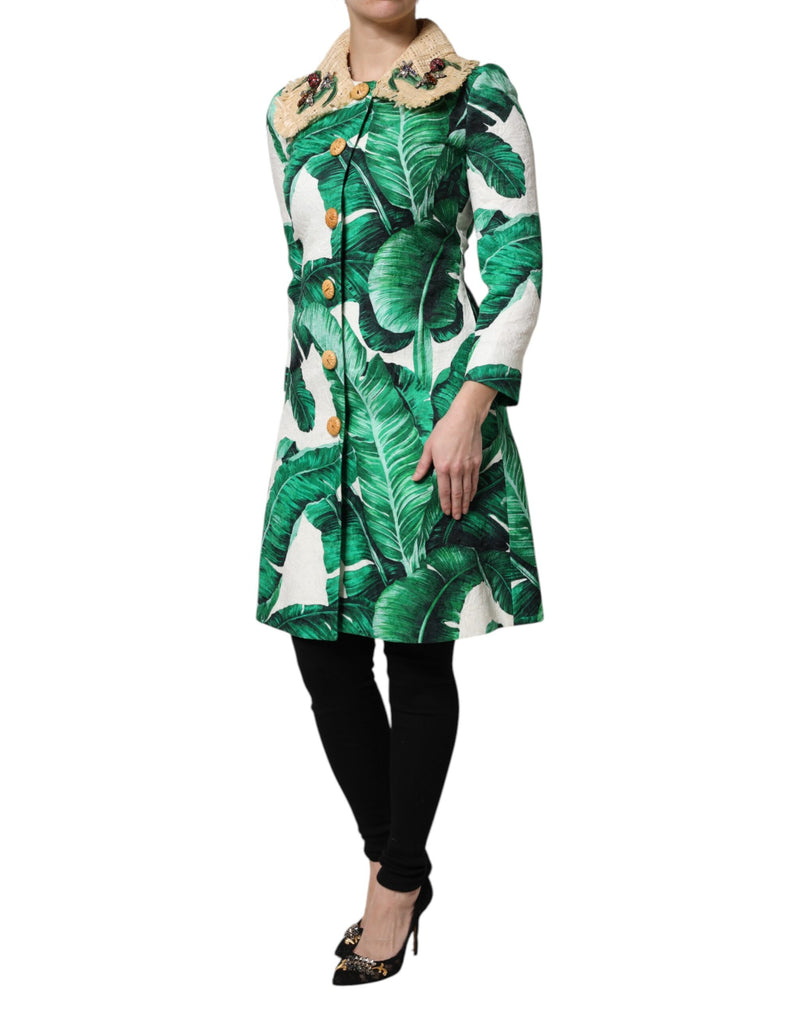 Green and white banana leaf print trench jacket with textured straw collar and embellished buttons