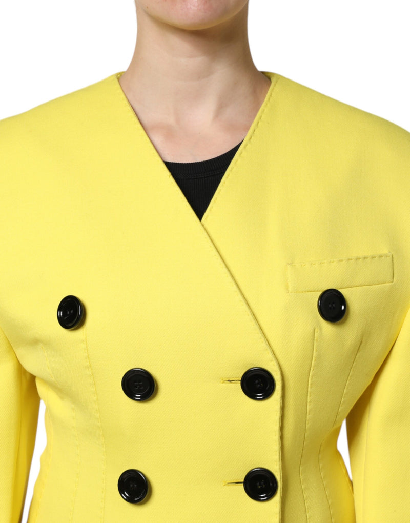 Bright yellow double-breasted jacket with black buttons and a collarless V-neck design