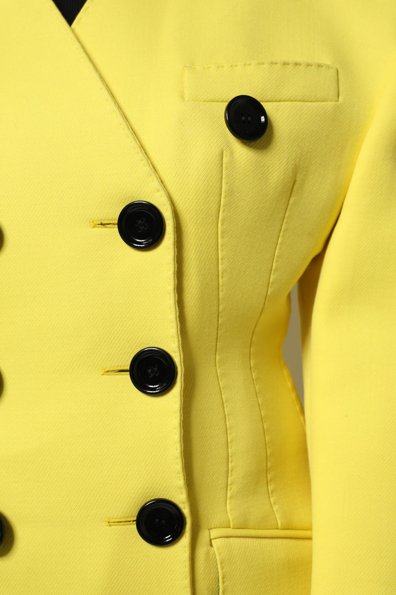 Bright yellow double-breasted jacket with black buttons and tailored seams
