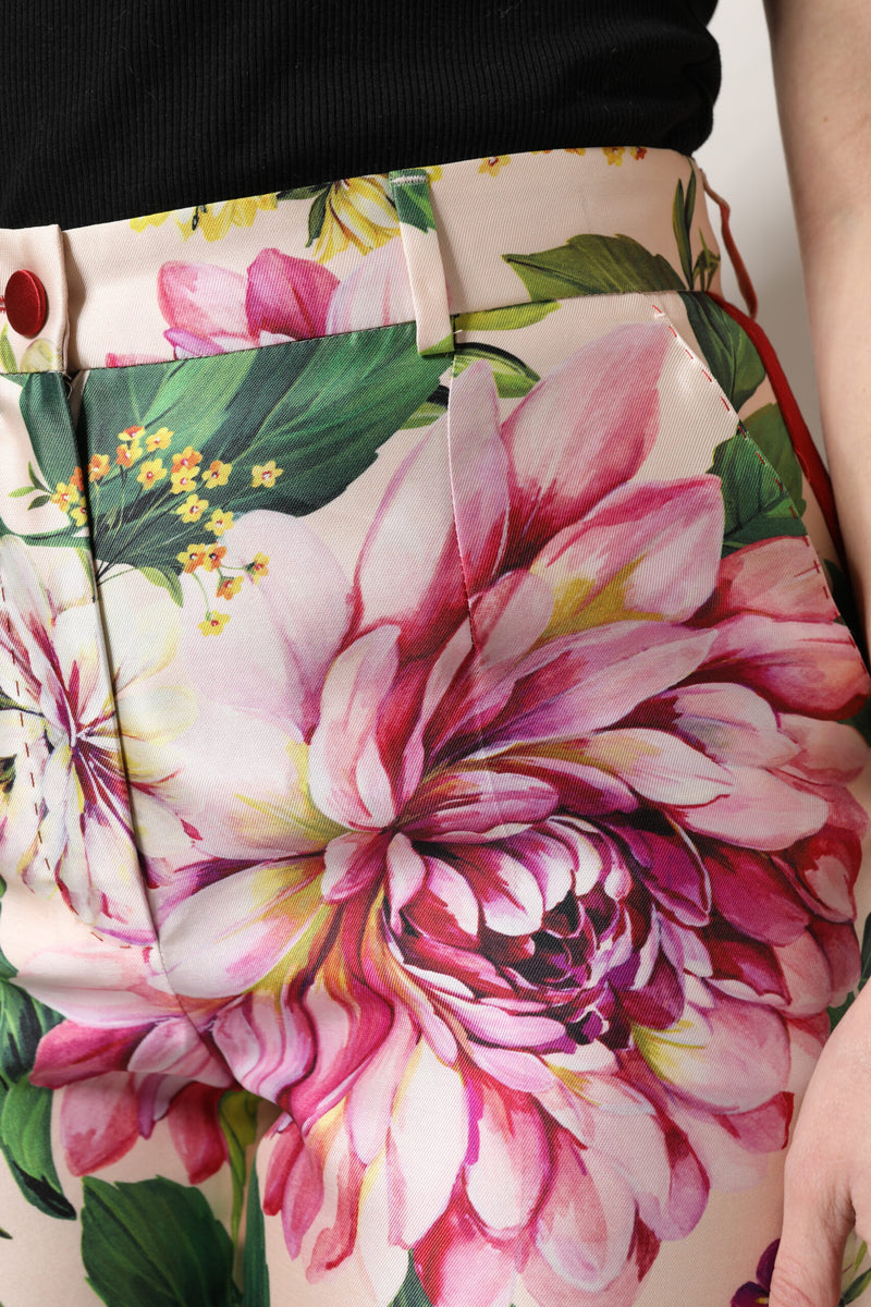 High-waist pink cotton pants featuring a vibrant multicolor floral print with large pink peonies and green leaves