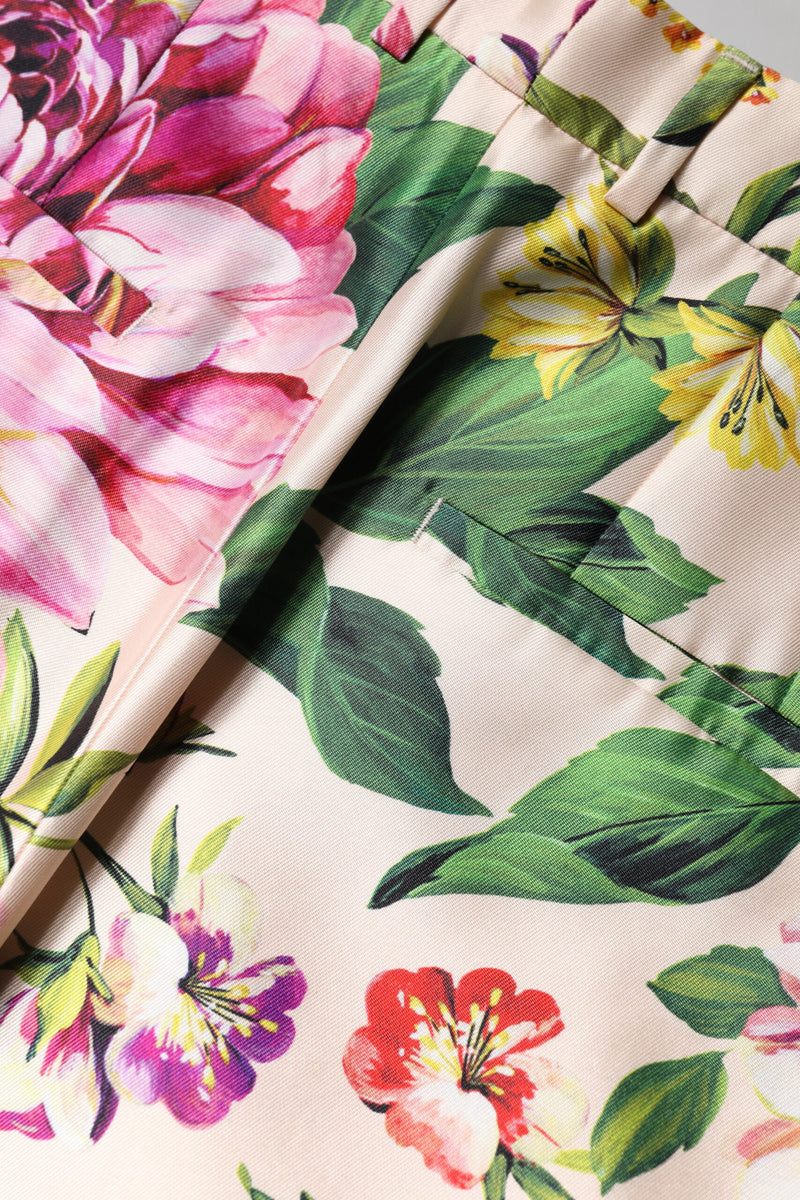 High waist straight pants in smooth pink fabric featuring a vibrant multicolor floral print with green leaves