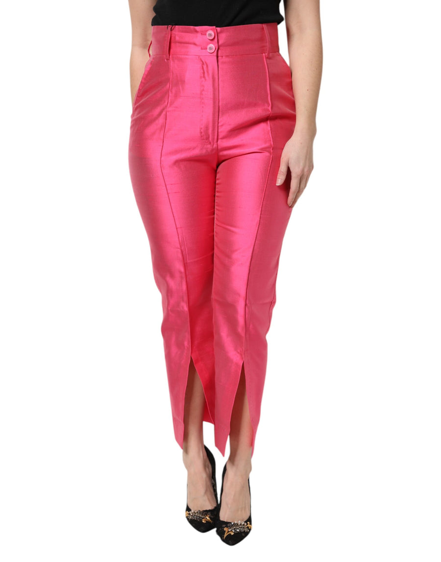Hot pink silk high-waist tapered pants with front slit hems worn by a model