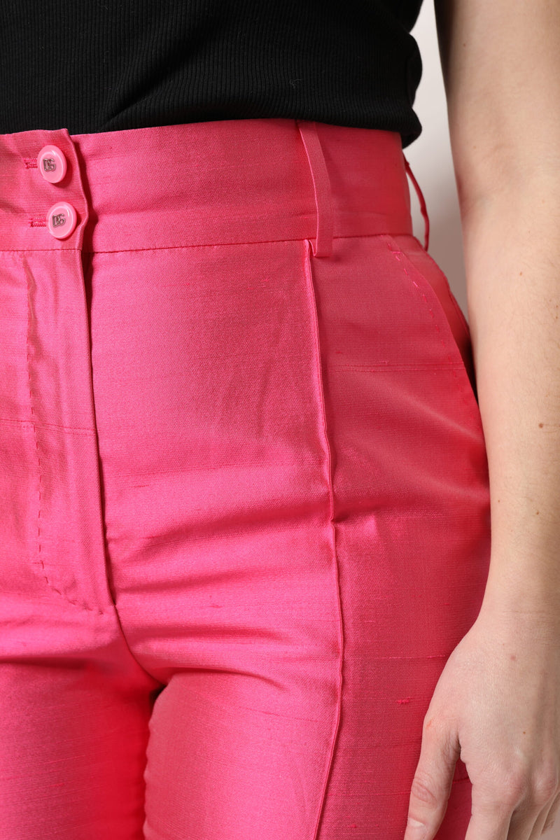Bright pink silk high-waist tapered pants with double button closure