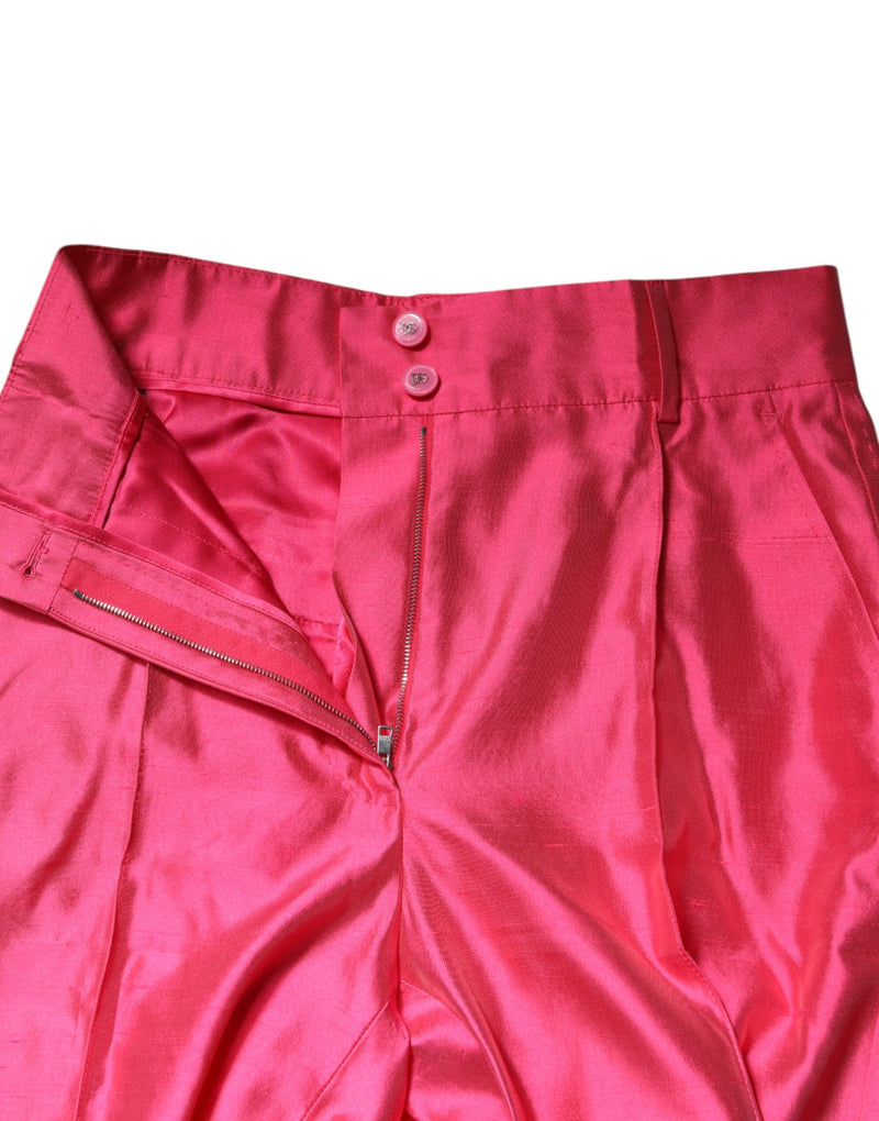 Pink silk high-waist pleated pants with a button and zipper closure