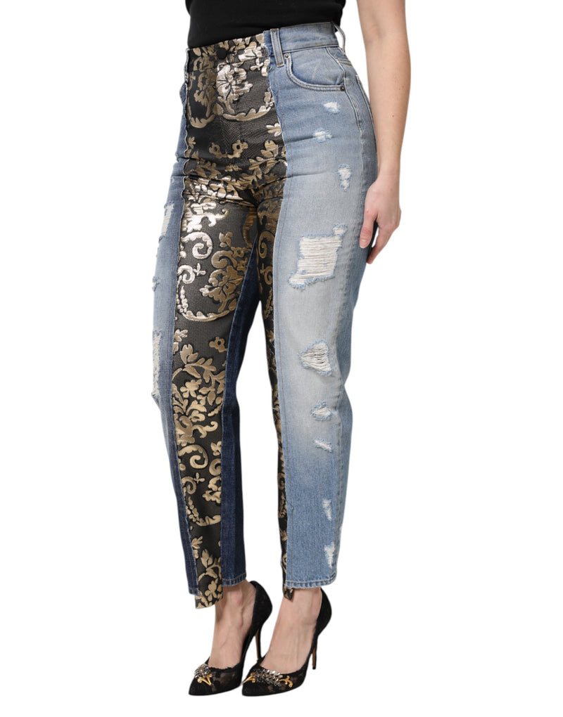 High-waist patchwork jeans with distressed blue denim on one side and black and gold brocade on the other