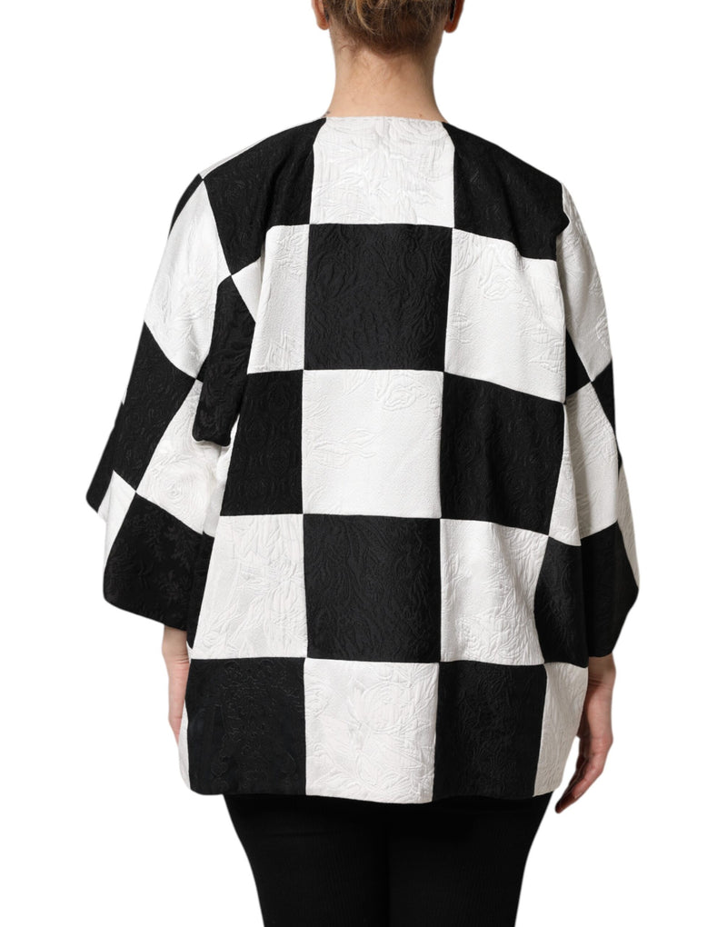 Black and white jacquard patchwork jacket with a checkered pattern worn by a person from behind