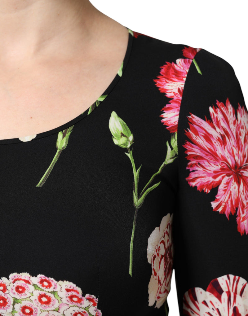 Black silk long sleeve blouse featuring a vibrant pink and white floral print with green stems