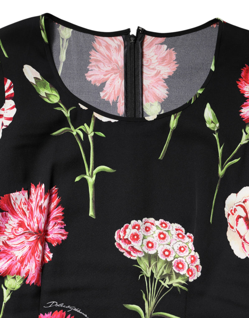 Black silk blouse featuring a vibrant pink and white carnation floral print with a back zipper
