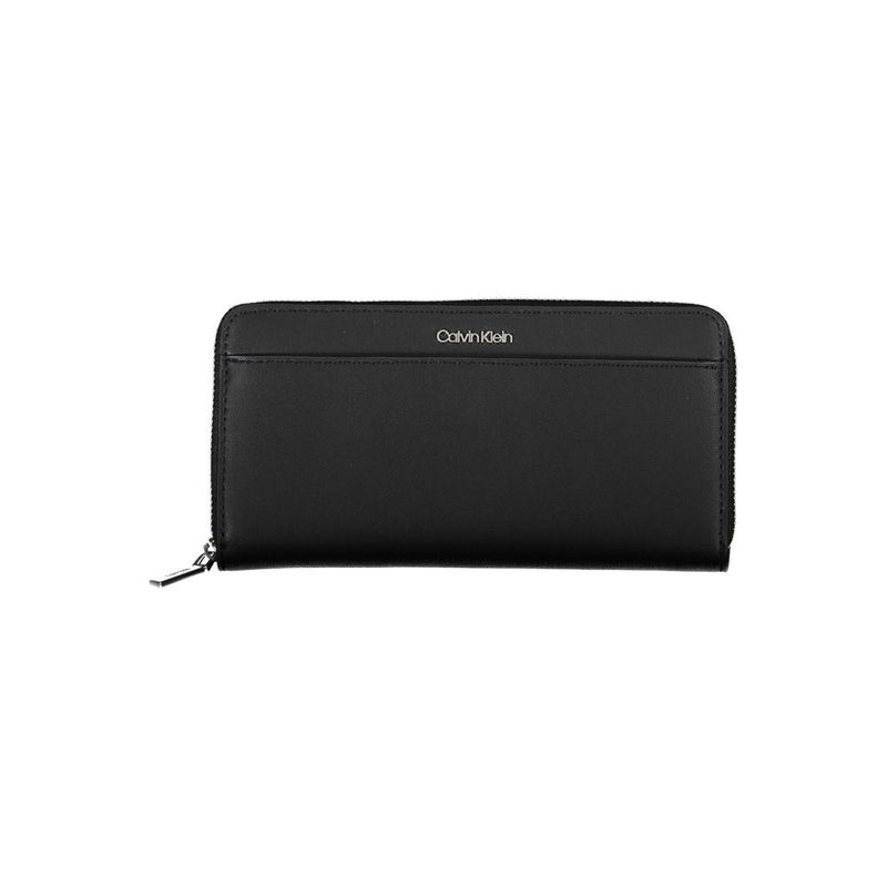 Black polyurethane Calvin Klein women's zip-around wallet with silver logo lettering