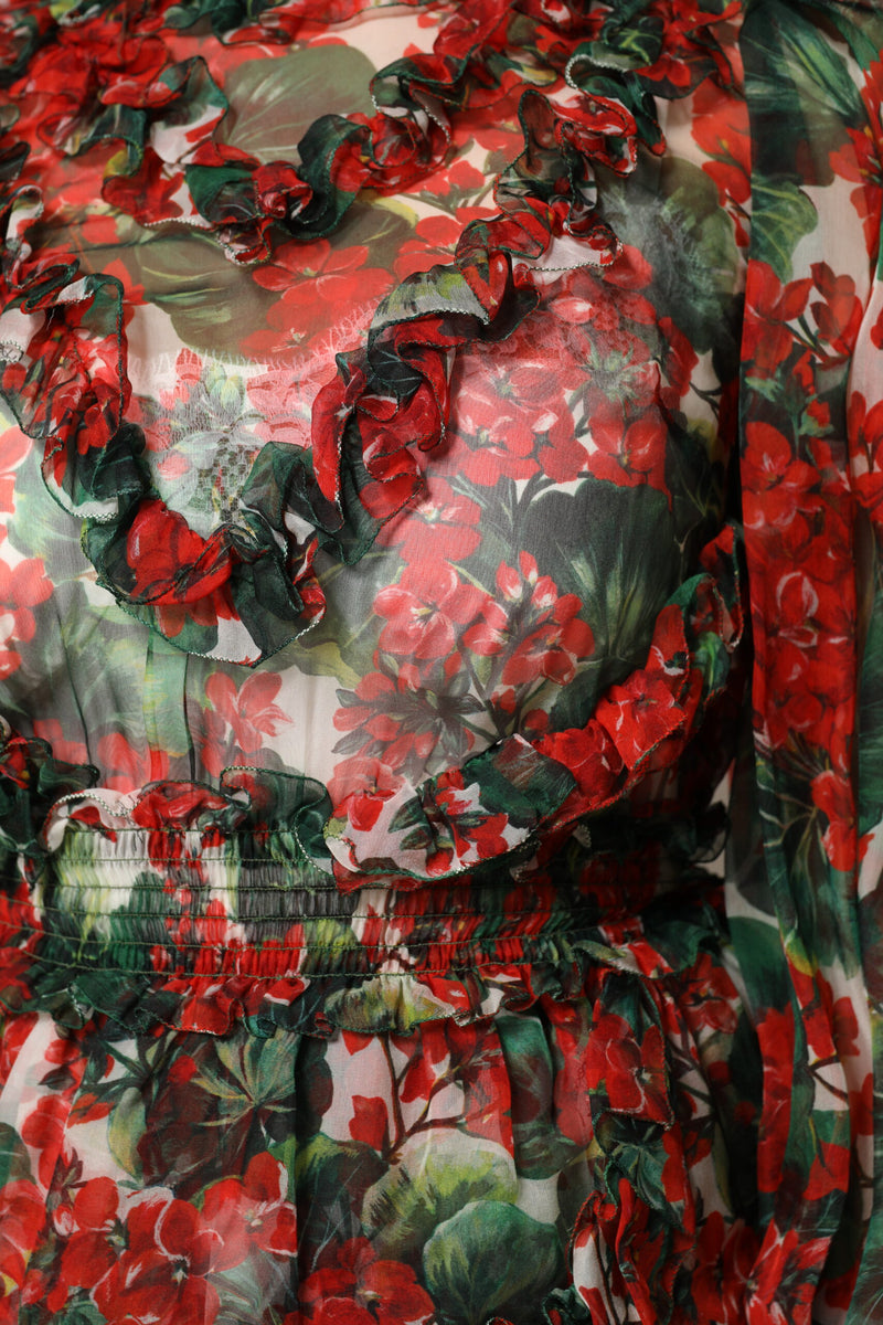 Sheer red and green floral print silk dress with ruffled trim and smocked waist