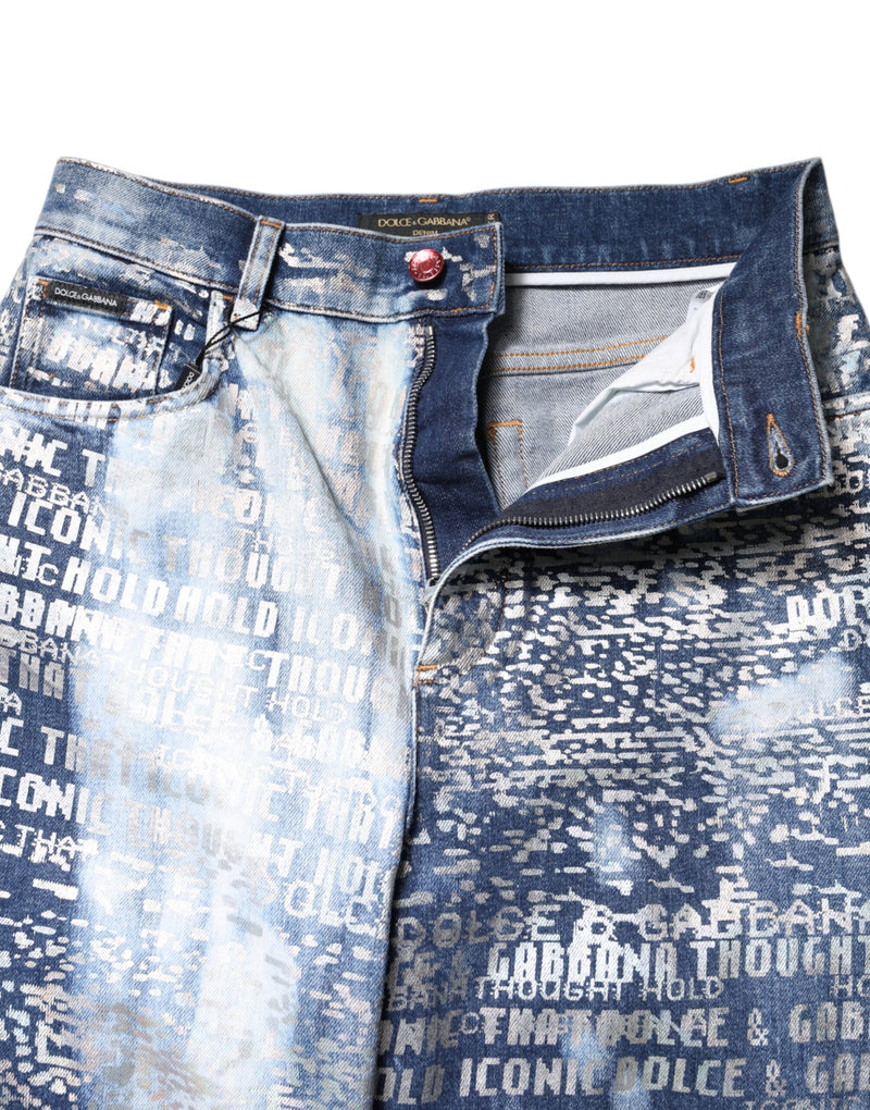 Blue washed denim high-waist jeans with white printed text graphics and a zippered fly