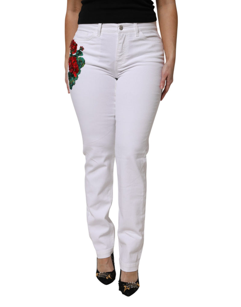 White denim jeans with red sequined floral embroidery on the right hip
