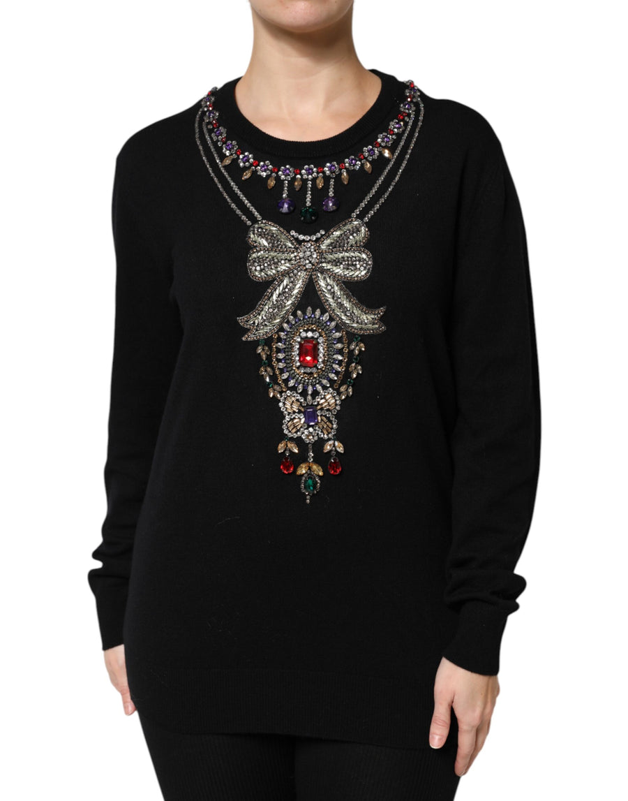 Black cashmere crewneck sweater with crystal and jewel embellishments forming a necklace and bow pattern