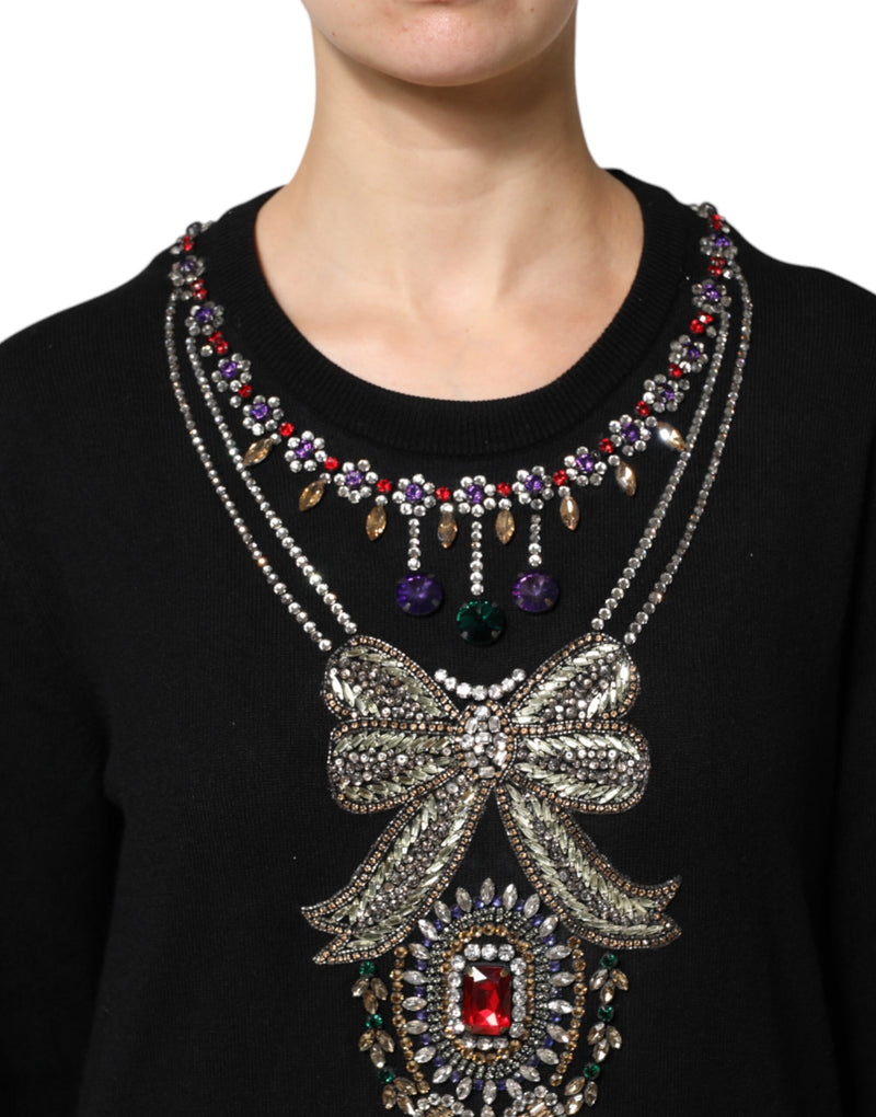 Black cashmere crewneck sweater with multicolored crystal necklace and bow embellishments