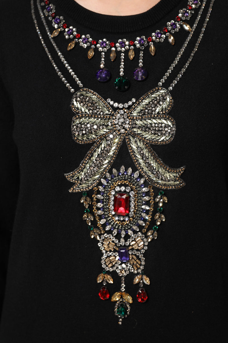 Black cashmere sweater with crystal embellished bow and gemstone necklace design