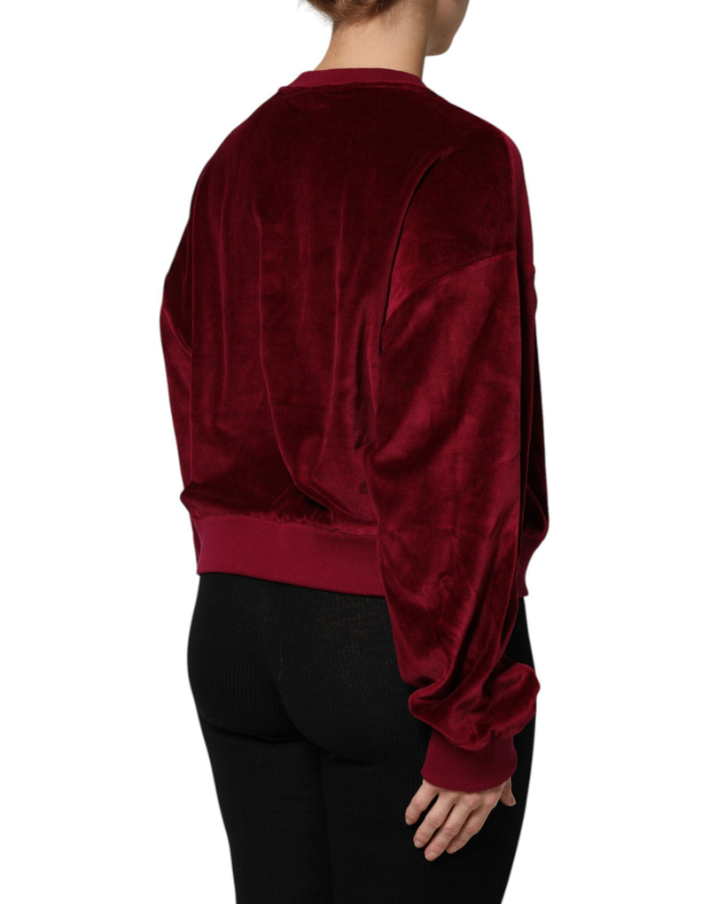 Red velvet crew neck pullover sweater seen from the back on a model