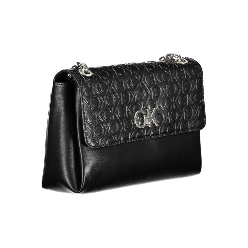 Black Calvin Klein polyester shoulder handbag with embossed monogram pattern and silver chain strap