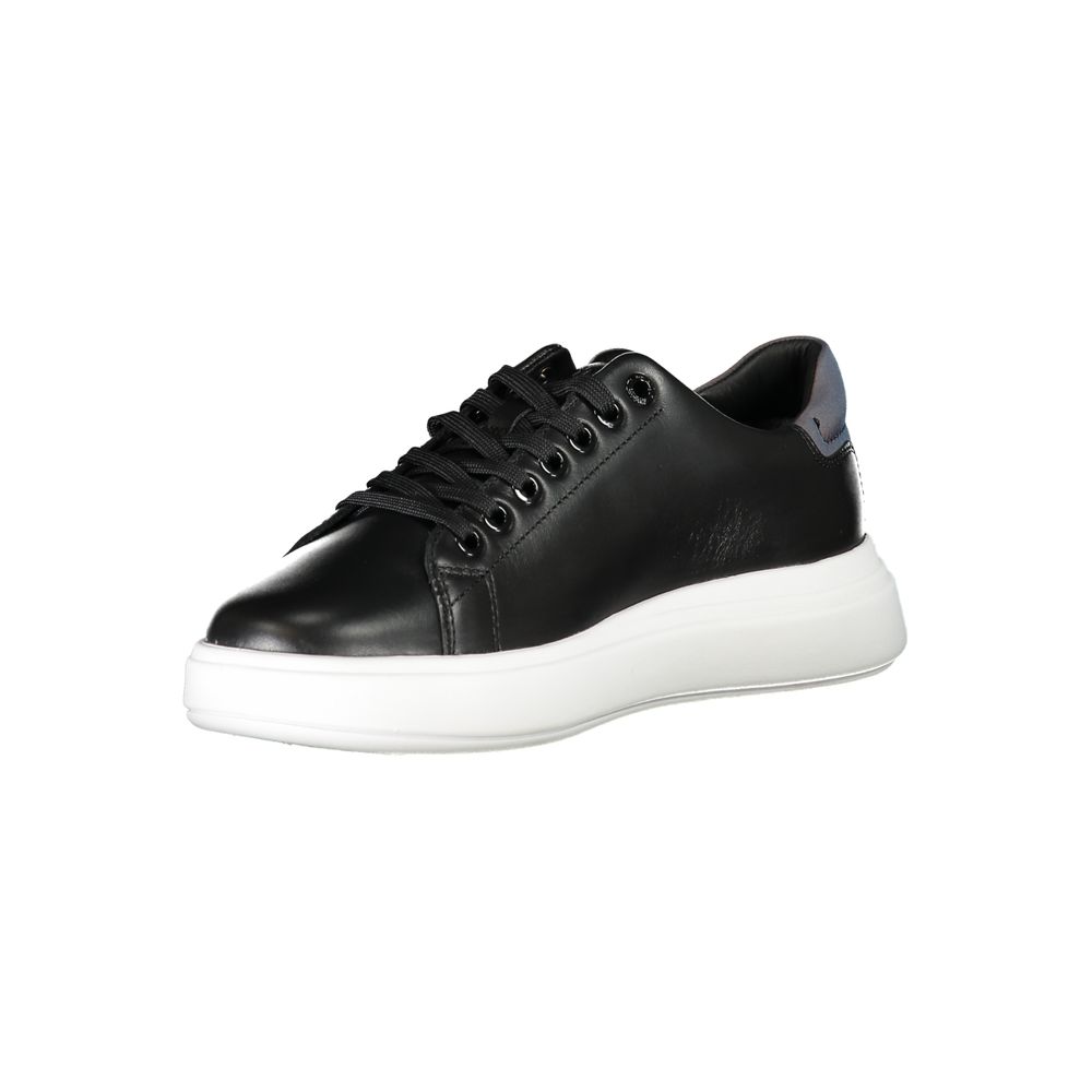 Calvin Klein black leather lace-up sneaker with a thick white platform sole and subtle metallic heel accent.
