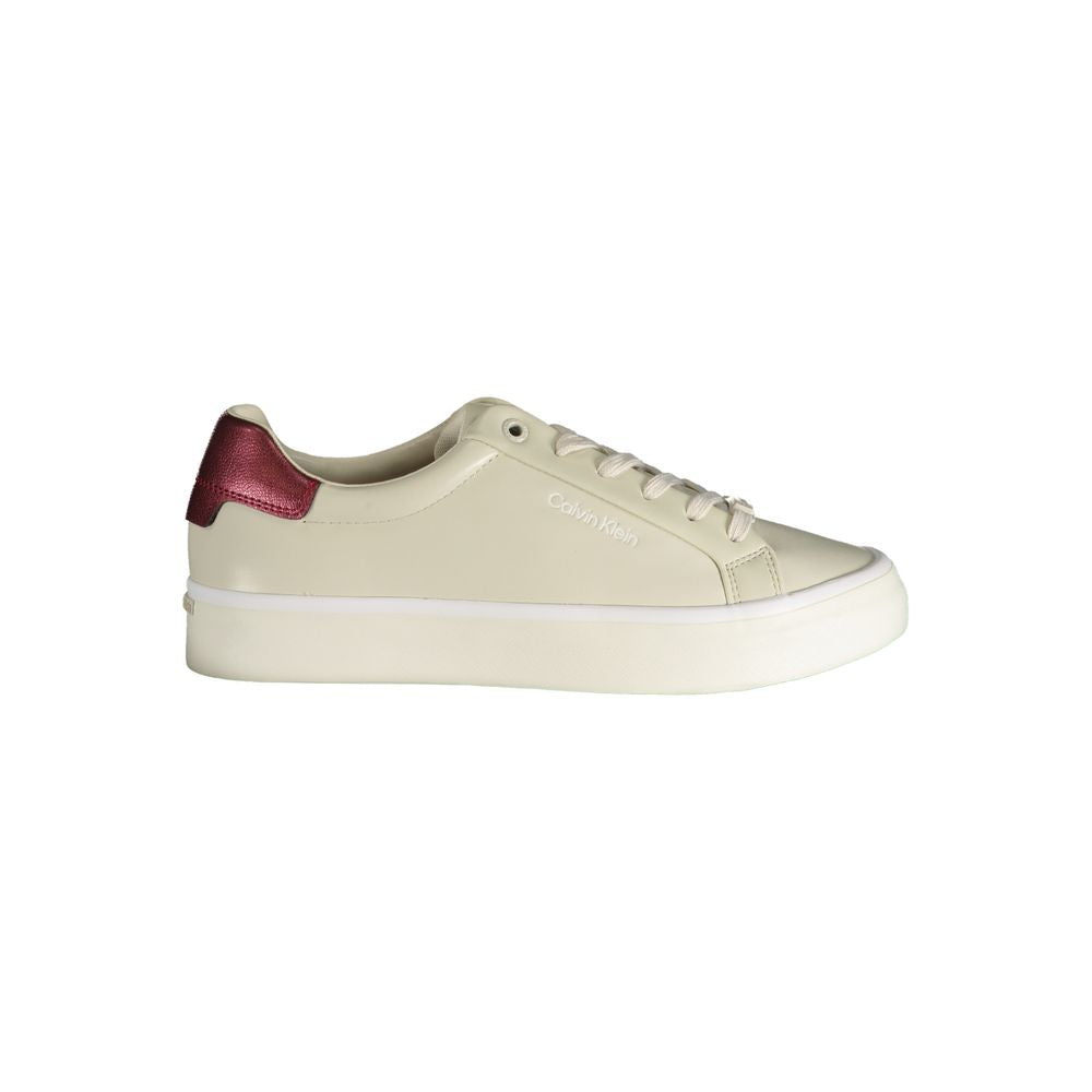 Beige leather Calvin Klein women’s sneaker with a thick white platform sole and metallic pink heel detail.