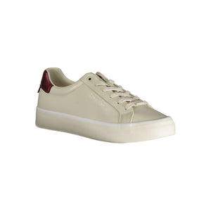 Calvin Klein women's beige leather sneakers with lace-up closure and a metallic red heel detail.