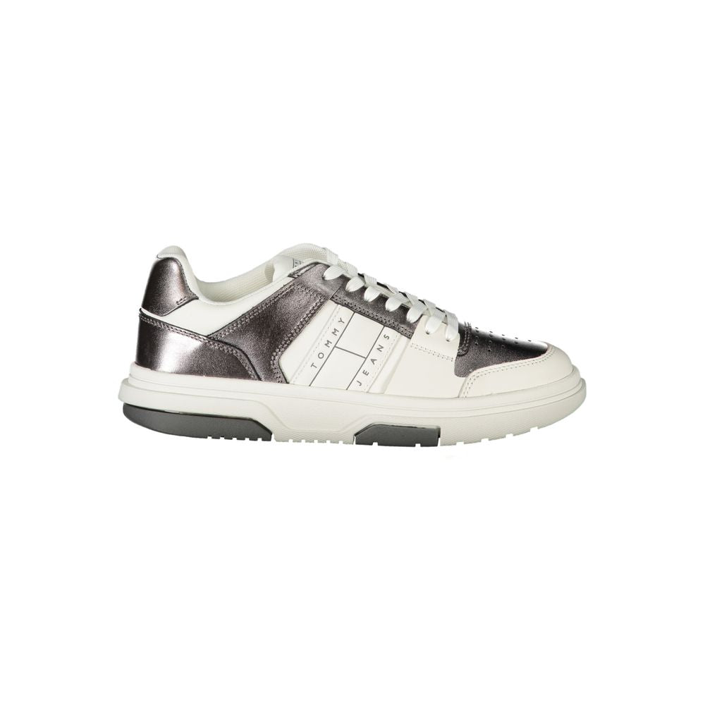 Tommy Hilfiger women's sneaker in white and metallic silver polyurethane with lace-up style and chunky sole.