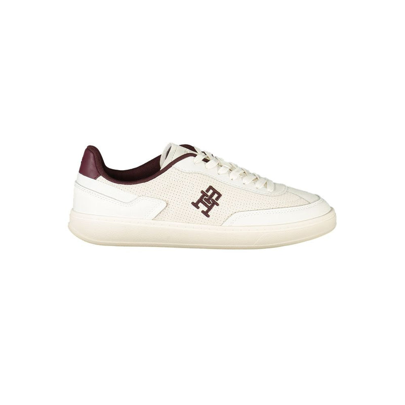Tommy Hilfiger women’s beige polyurethane sneaker with maroon logo detailing and a classic lace-up tennis style.