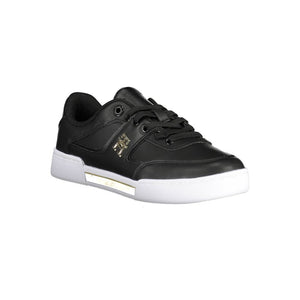 Tommy Hilfiger black polyester women’s sneaker with gold side logo, lace-up front, and chunky white rubber sole.