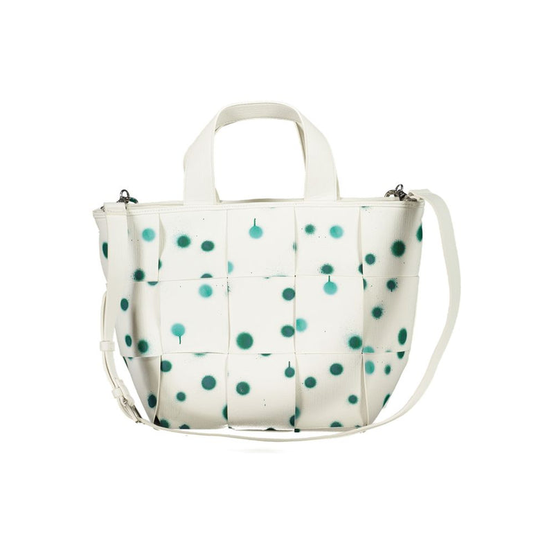 White polyurethane woven handbag with green spray paint dot pattern, top handles and shoulder strap