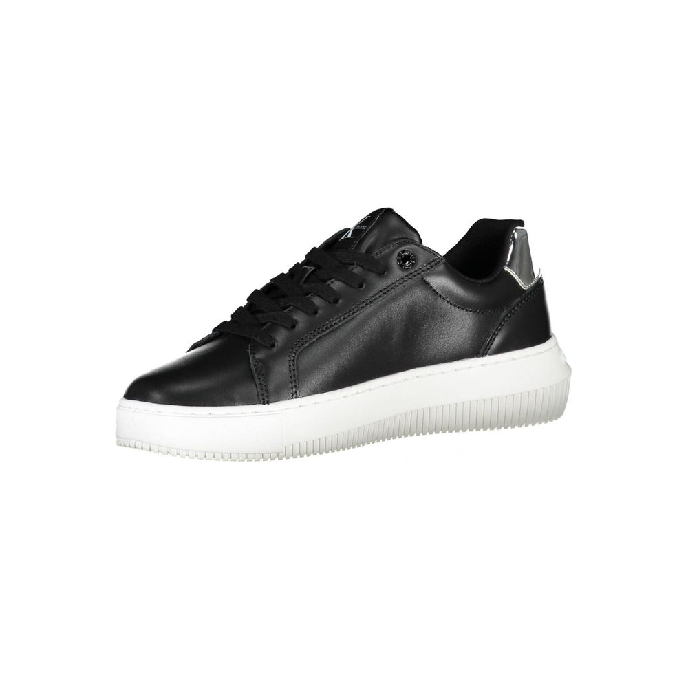 Calvin Klein black leather women’s sneaker with a white platform sole and silver heel detail.