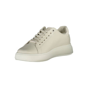 Calvin Klein women’s beige leather low-top sneaker with a thick sole and matching lace-up closure.
