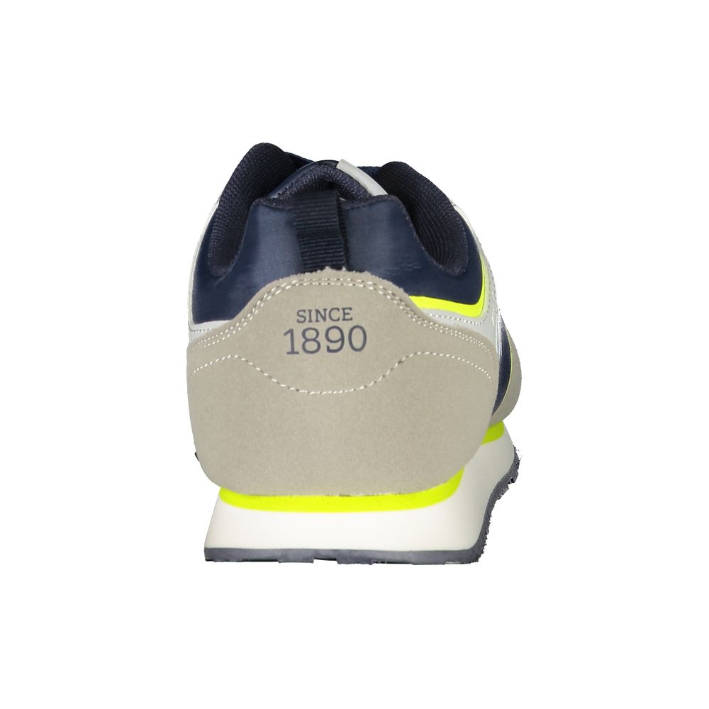 Blue polyester U.S. Polo Assn. women’s sneaker with beige suede heel detail, neon yellow trim, and white sole.