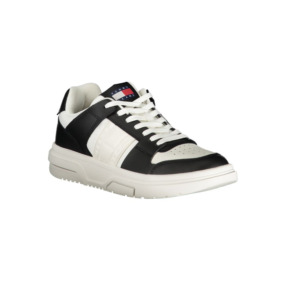 Tommy Hilfiger women's black and white leather low-top sneaker with white laces and logo tongue patch.