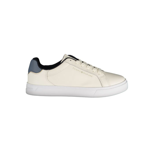 Tommy Hilfiger women's beige leather sneaker with a white sole, blue heel tab, and gold branding details.