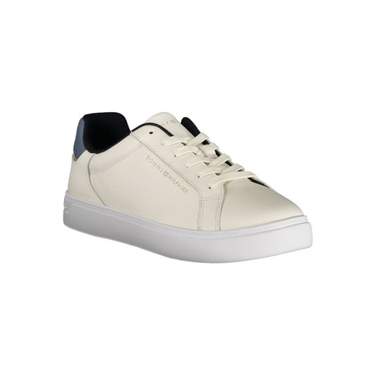 Tommy Hilfiger beige leather women’s sneaker with white sole, dark blue heel tab, and gold-tone side logo.