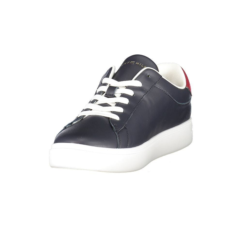 Tommy Hilfiger blue polyurethane women's sneaker with white laces, a thick white sole, and red heel accent.