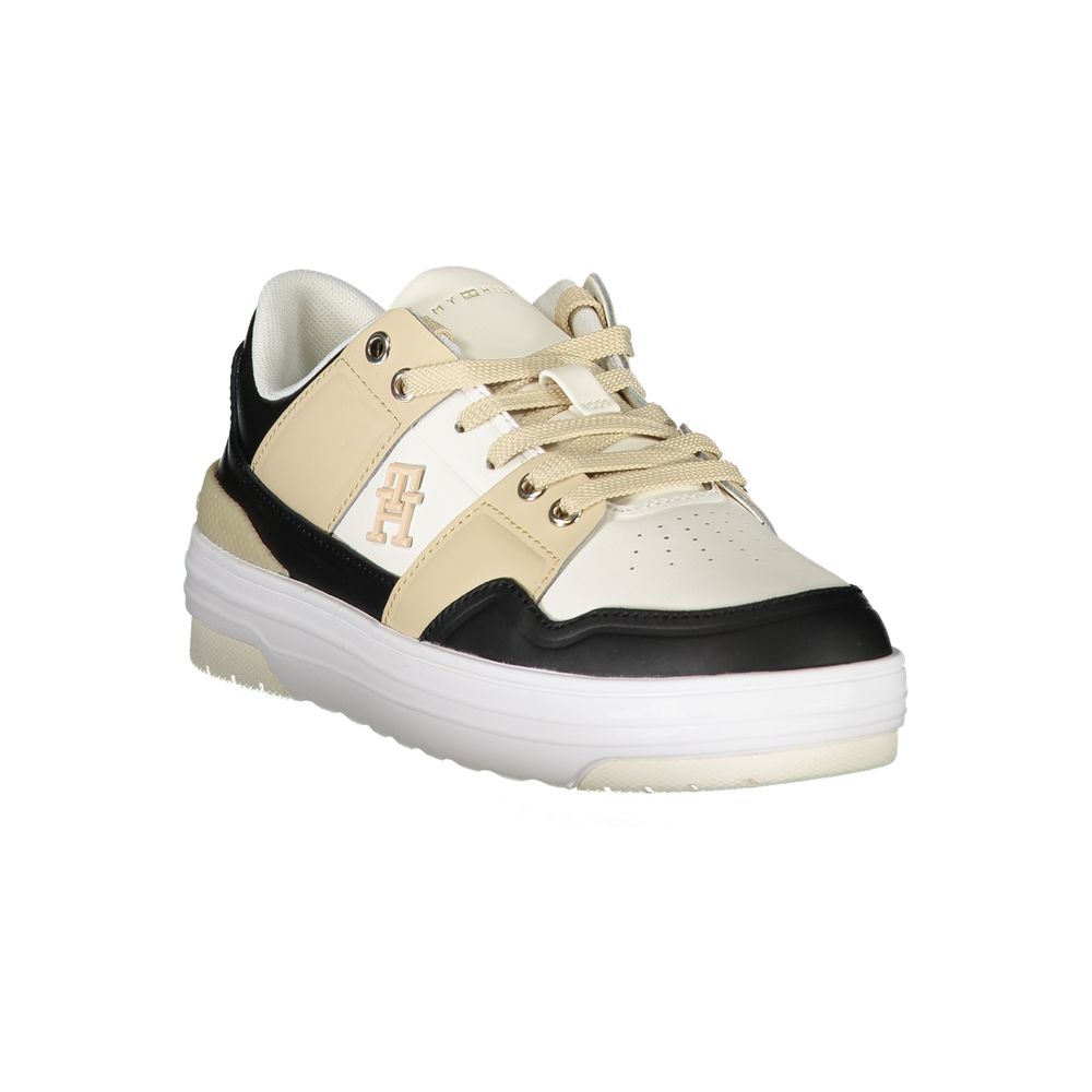 Tommy Hilfiger women's white, black, and beige leather low-top sneaker with lace-up style and branding.