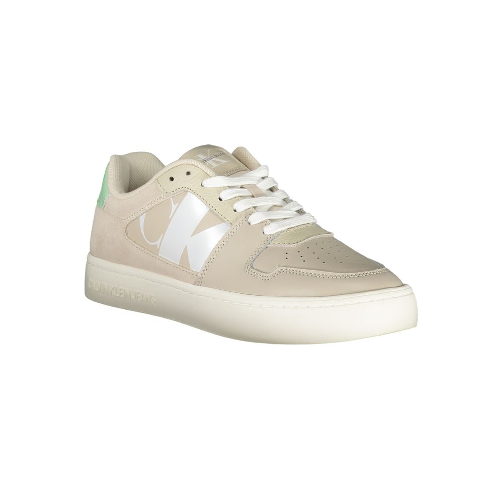 Calvin Klein women's beige polyurethane lace-up sneaker with large white logo and green heel accent.