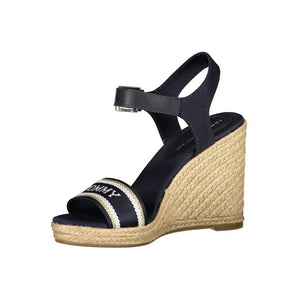 Navy blue Tommy Hilfiger wedge sandal with jute-wrapped heel, buckled strap, and branded canvas toe band.