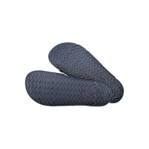 Pair of blue Fila women’s polyurethane slippers, showing the chevron-patterned non-slip outer soles.