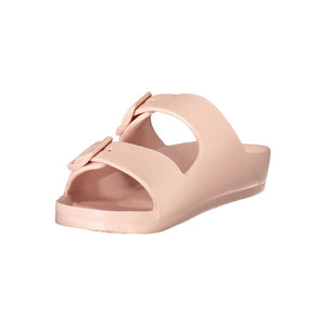 Women’s blush pink plastic ciabatta sandals with double buckle straps in a minimalist slip-on style.